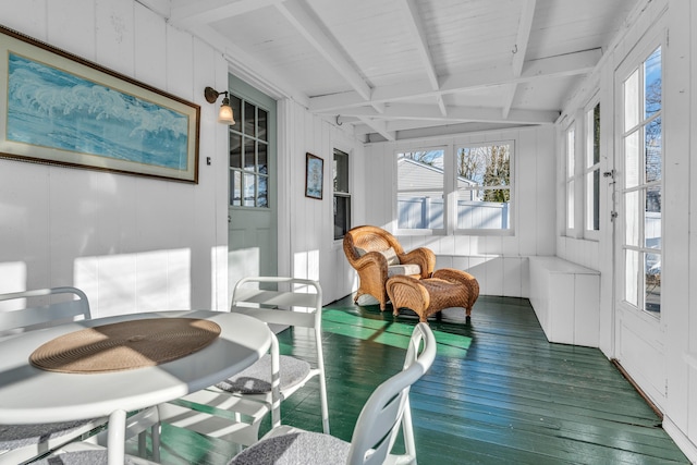 sunroom / solarium with beamed ceiling and a healthy amount of sunlight