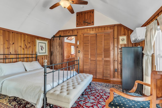 bedroom featuring vaulted ceiling, a wall mounted AC, ceiling fan, a closet, and wood walls