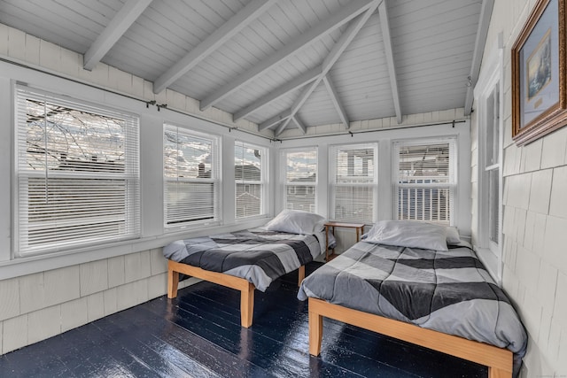 bedroom featuring dark hardwood / wood-style flooring and lofted ceiling with beams