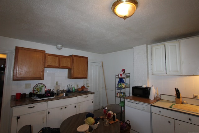 kitchen featuring white cabinets, dishwasher, a textured ceiling, and tasteful backsplash