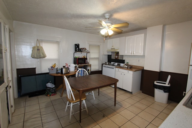 kitchen featuring white electric stove, ceiling fan, light tile patterned floors, a textured ceiling, and white cabinetry