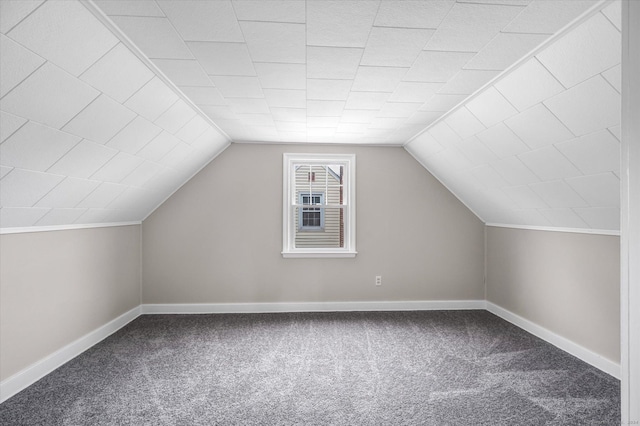 additional living space with carpet flooring and vaulted ceiling