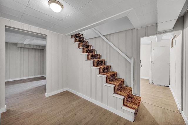 staircase with hardwood / wood-style flooring