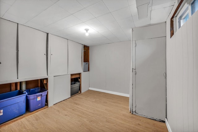 basement with light hardwood / wood-style flooring