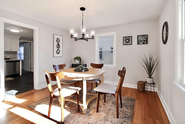 dining space featuring an inviting chandelier and hardwood / wood-style flooring