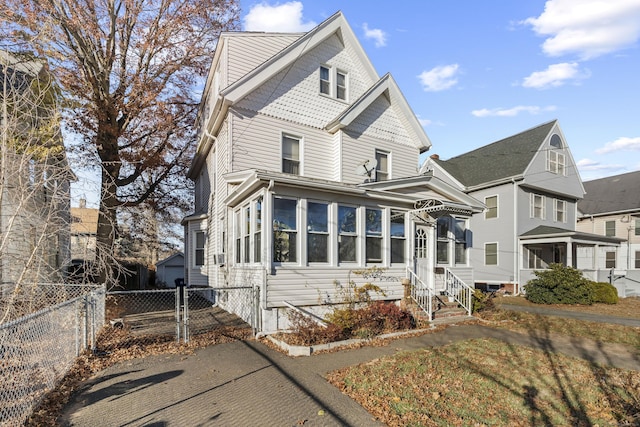 view of front of home featuring a sunroom