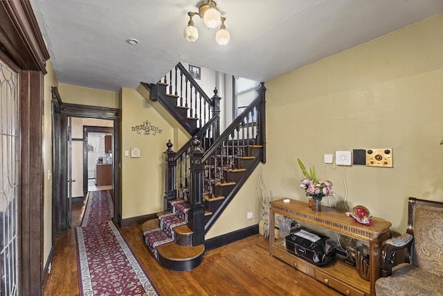 staircase with hardwood / wood-style flooring