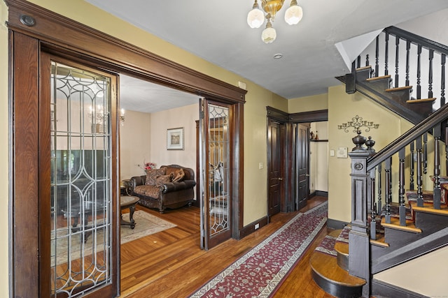 foyer featuring dark hardwood / wood-style floors and an inviting chandelier