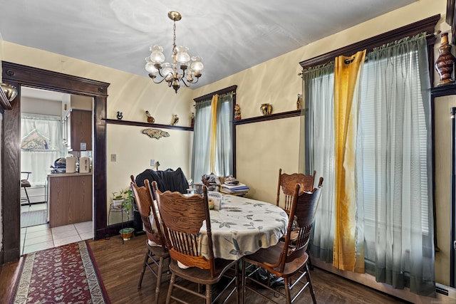 dining room featuring hardwood / wood-style floors and a notable chandelier