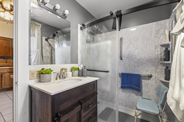 bathroom featuring tile patterned flooring, vanity, and a shower with shower door