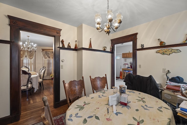 dining room featuring a notable chandelier and dark hardwood / wood-style floors