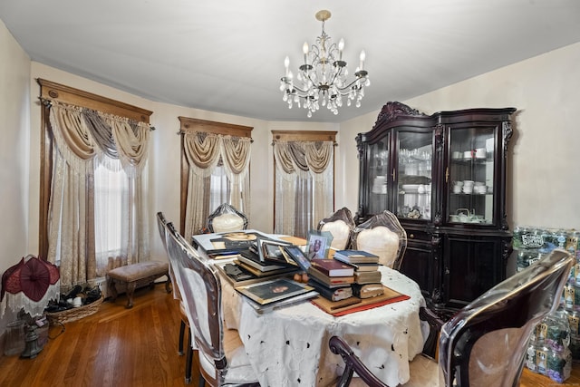 dining area featuring hardwood / wood-style floors and a chandelier