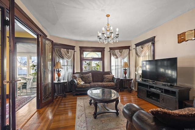 living room featuring dark wood-type flooring and a notable chandelier