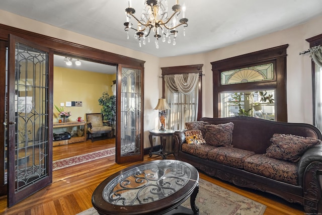 living room featuring a notable chandelier and hardwood / wood-style flooring