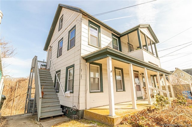 625 N Main St, Norwich, CT 06360 - view of property exterior with covered porch, stairway, and a balcony