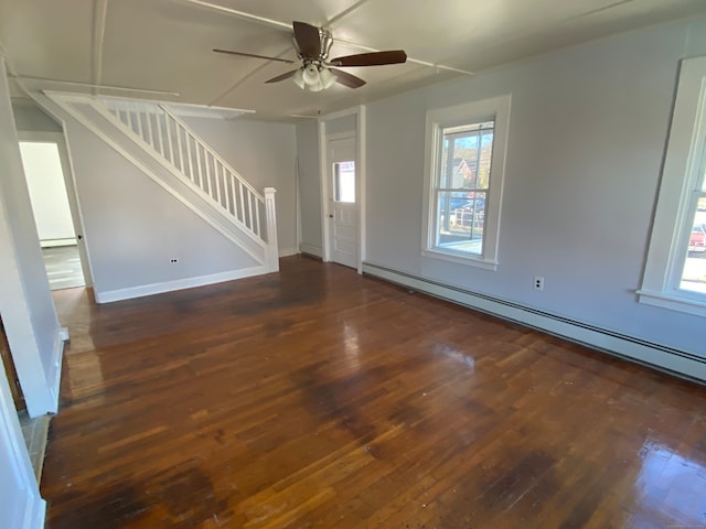 unfurnished living room with dark hardwood / wood-style floors, ceiling fan, and a baseboard heating unit