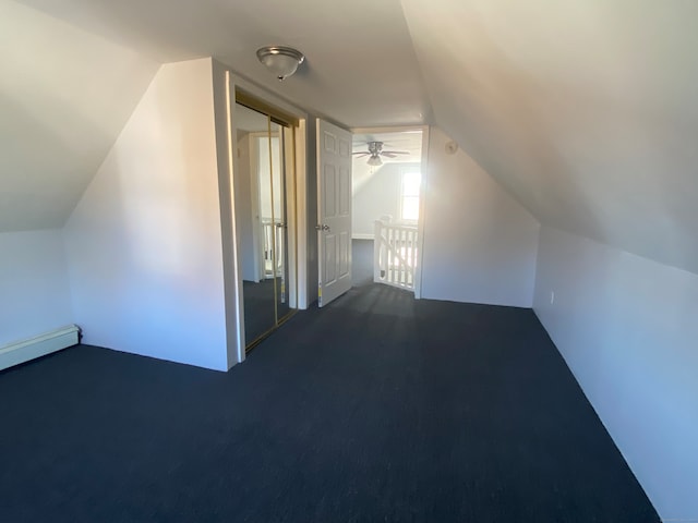 bonus room featuring ceiling fan, dark carpet, and lofted ceiling