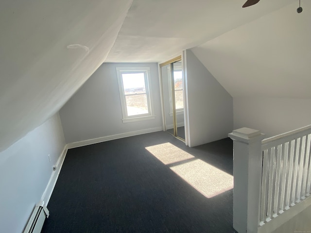 bonus room with ceiling fan, a baseboard radiator, lofted ceiling, and dark carpet