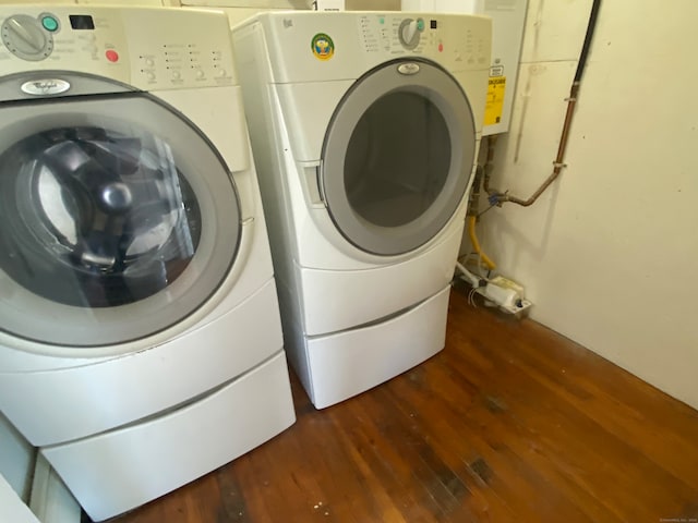 laundry area featuring dark hardwood / wood-style flooring and washing machine and dryer