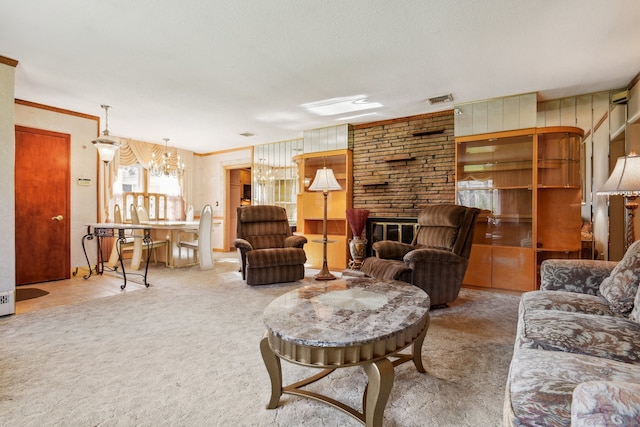 carpeted living room with a textured ceiling, crown molding, a fireplace, and a chandelier