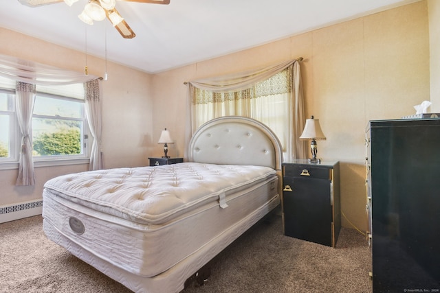 carpeted bedroom featuring ceiling fan and a baseboard heating unit