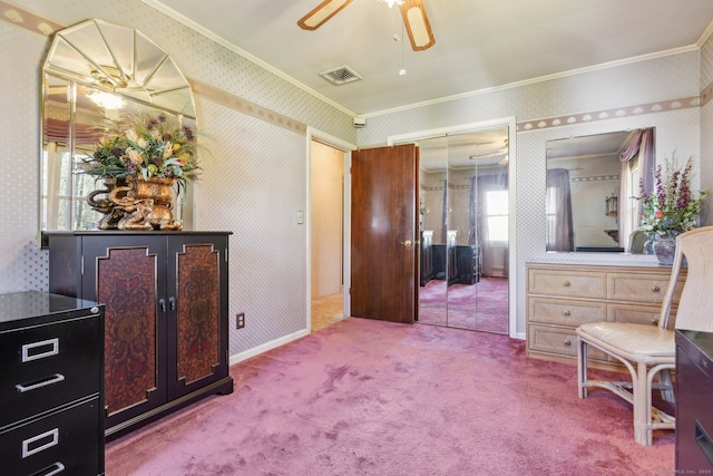 living area with carpet flooring, crown molding, ceiling fan, and a healthy amount of sunlight