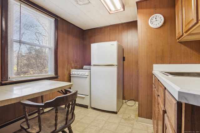 kitchen with white appliances and wooden walls