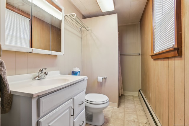 bathroom featuring walk in shower, baseboard heating, wood walls, toilet, and vanity