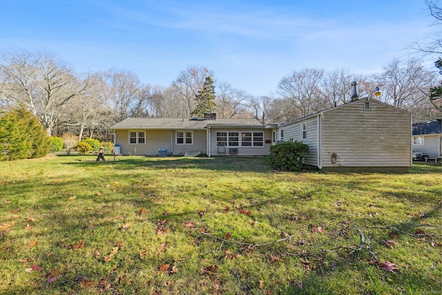 rear view of property with a lawn