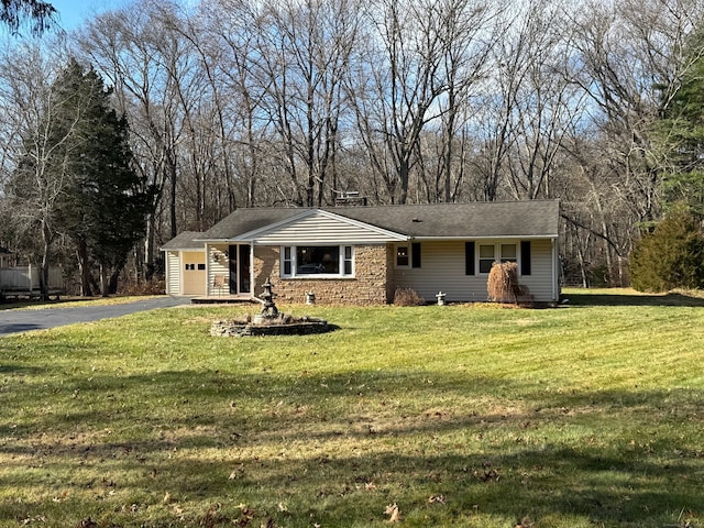 ranch-style home with a garage and a front yard