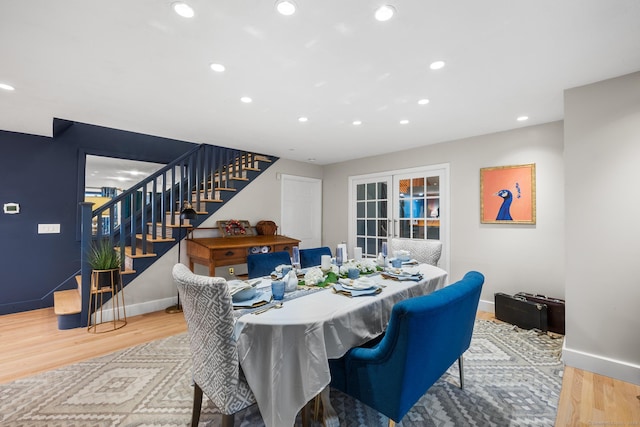 dining area with hardwood / wood-style floors and french doors