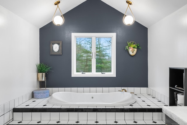 bathroom featuring tiled tub and vaulted ceiling