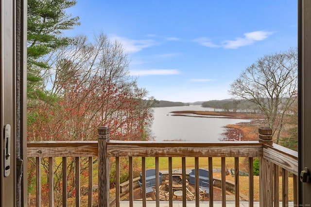 wooden deck featuring a water view