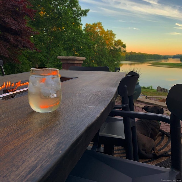 exterior space with a water view and an outdoor fire pit