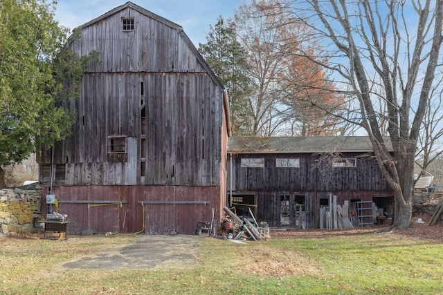 view of outbuilding featuring a lawn