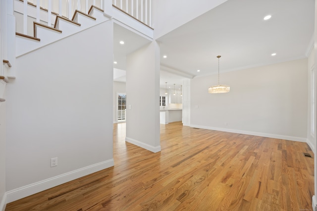 unfurnished room featuring light wood-type flooring and ornamental molding