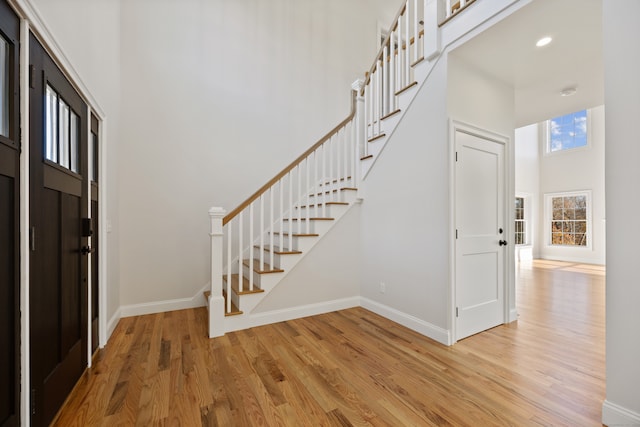 foyer featuring a high ceiling and light hardwood / wood-style flooring