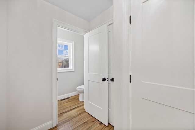 hallway with light hardwood / wood-style flooring