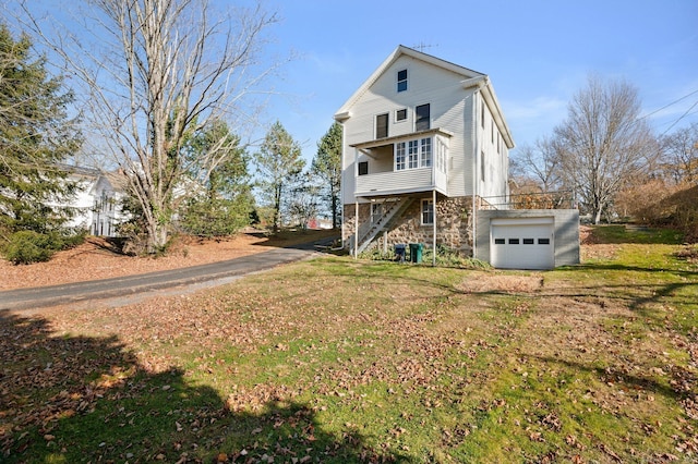 46 Lyme St, Old Lyme, CT 06371 - back of house with stairway, stone siding, a garage, and a yard