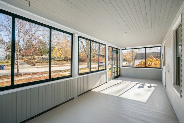 unfurnished sunroom featuring plenty of natural light and wood ceiling