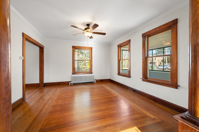 unfurnished room featuring radiator heating unit, ceiling fan, and crown molding