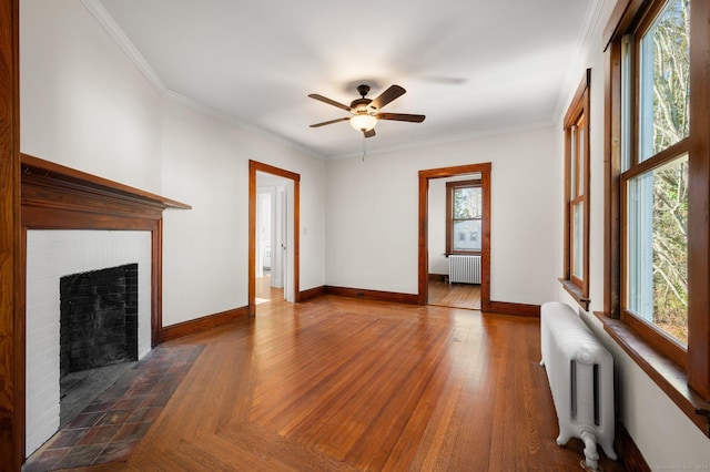 46 Lyme St, Old Lyme, CT 06371 - unfurnished living room with radiator, a ceiling fan, ornamental molding, a fireplace with flush hearth, and wood finished floors