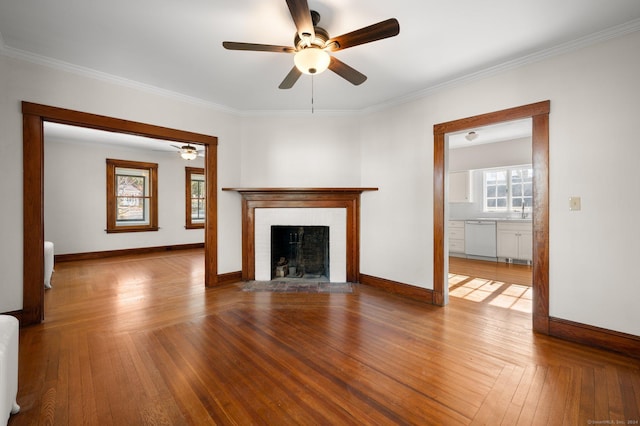 46 Lyme St, Old Lyme, CT 06371 - unfurnished living room featuring ceiling fan, a fireplace with flush hearth, crown molding, and wood finished floors