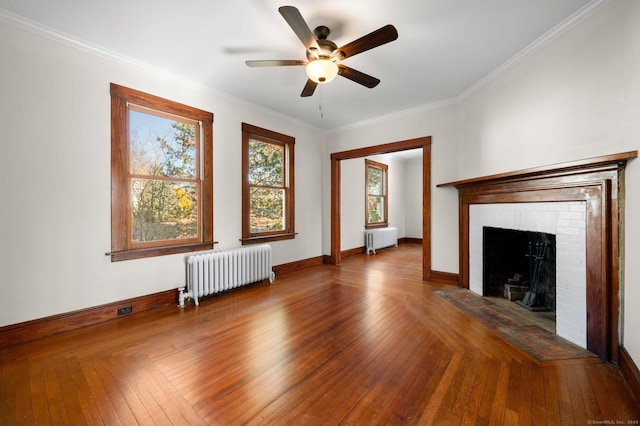 46 Lyme St, Old Lyme, CT 06371 - unfurnished living room with radiator, a ceiling fan, a brick fireplace, crown molding, and wood-type flooring