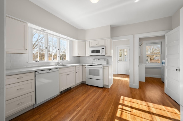 46 Lyme St, Old Lyme, CT 06371 - kitchen featuring white appliances, tasteful backsplash, white cabinets, light countertops, and light wood-style floors