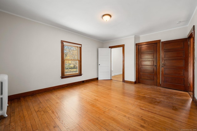 46 Lyme St, Old Lyme, CT 06371 - unfurnished bedroom featuring light wood-style flooring, ornamental molding, a closet, and radiator heating unit