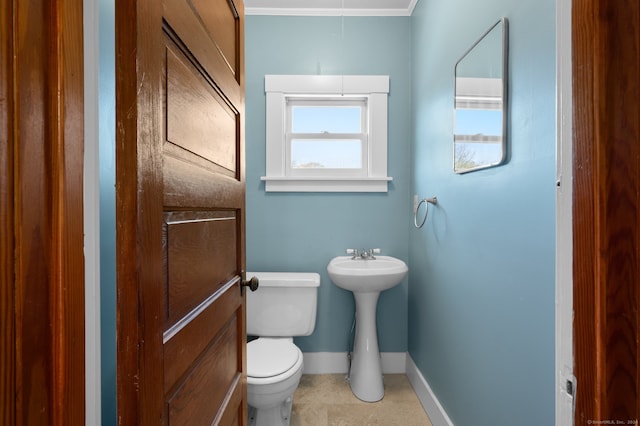 bathroom featuring tile patterned flooring, toilet, and ornamental molding