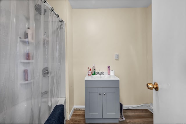 bathroom featuring hardwood / wood-style floors, vanity, and tiled shower / bath