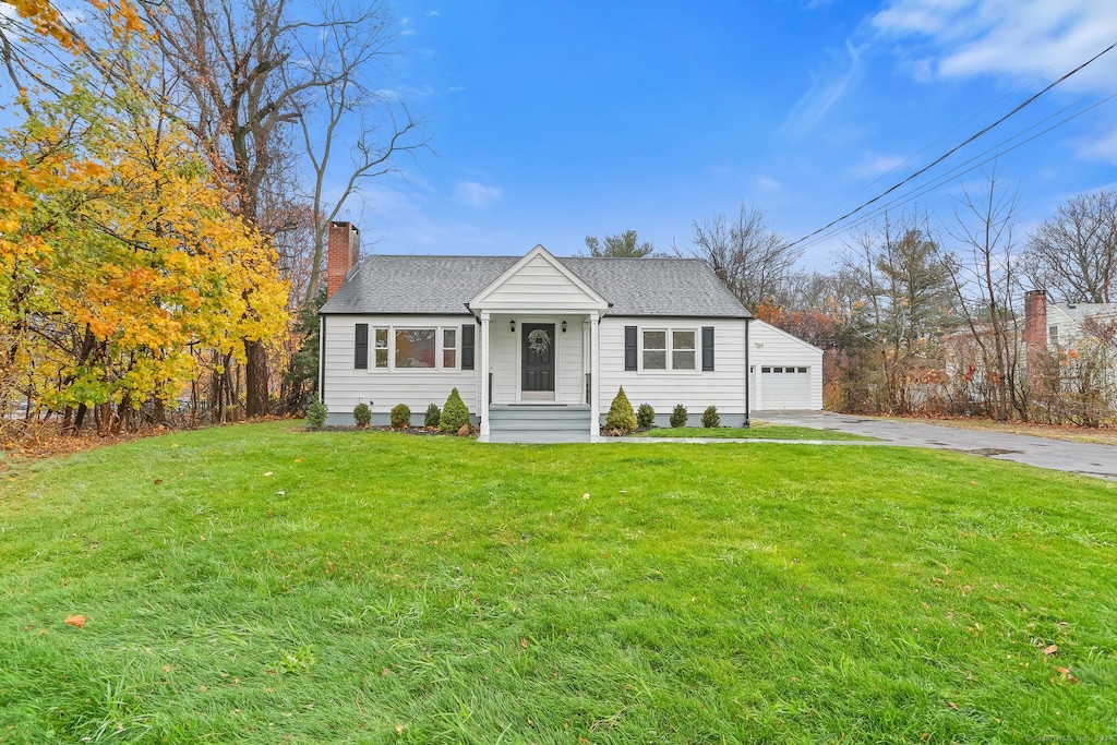 view of front facade featuring a garage and a front lawn