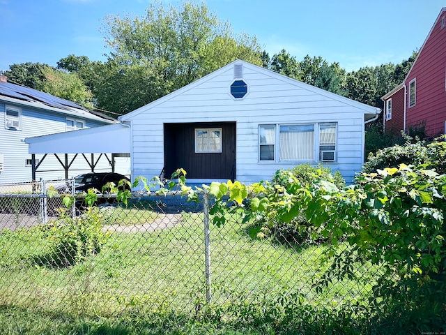 view of front facade featuring a carport and a front yard